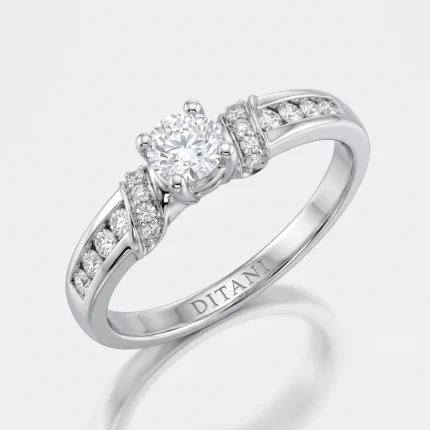Diamond engagement ring with a large round center stone in four prongs and pavé diamonds along a white-gold band.