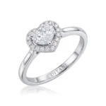 Engagement ring in white gold featuring a central round diamond with a heart-shaped diamond halo and small side diamonds on the halo, brand-inscribed band interior.