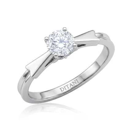 Silver ring with a round brilliant-cut diamond solitaire held by four prongs, inner band engraved with DITANI name.