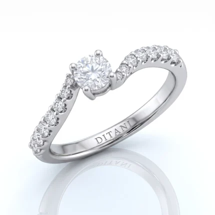Engagement ring with a prominent center diamond and diamonds along the band in white metal setting.