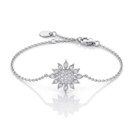 Silver bracelet with a sunburst diamond centerpiece on a white background.