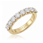 Gold ring with a row of round-cut diamonds along the top, held by prongs, and an interior engraving reading DITANI.
