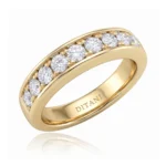 Gold ring in yellow gold with a row of round diamonds along the top, set in prongs, interior stamped DITANI