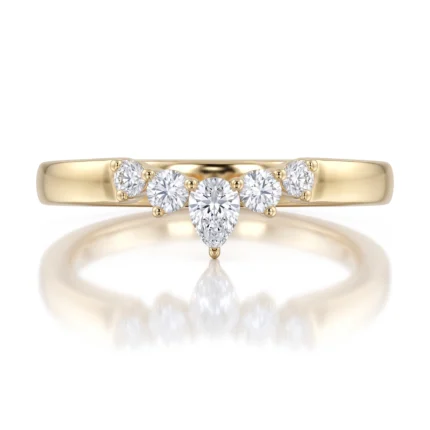 Yellow gold ring featuring a pear-shaped center diamond with smaller round diamonds set along a curved arc across the band, creating a milgrain-like dotted look.