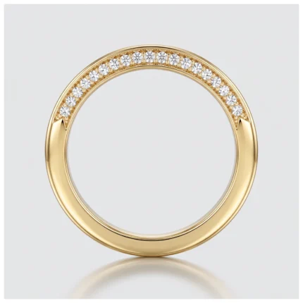Gold ring with a row of small diamonds along the upper edge, set in a yellow-gold band on a light background