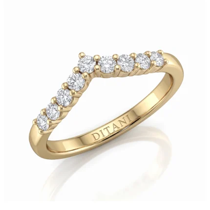 Gold ring with a row of diamonds along the curved top of the band, in a prong setting.