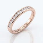 Rose gold band with a channel of diamonds along the top, engraved 'DITANI' inside