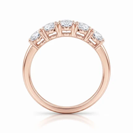 Rose gold ring with five diamonds set across the top in a gallery-style setting.