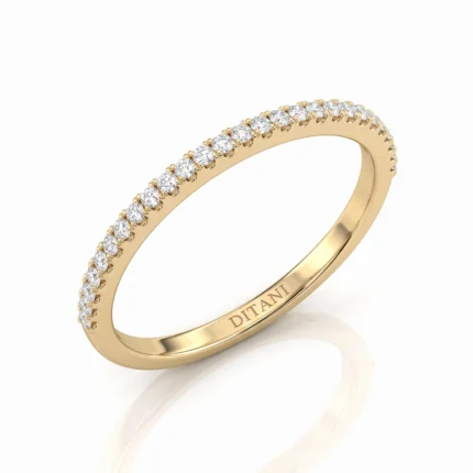 Gold band eternity ring with small diamonds along the top edge and 'DITANI' inside the band.