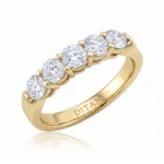 Gold five-stone ring with round-cut diamonds in prong settings and 'DITANI' engraved on the inner band