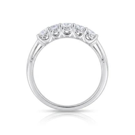Top-down view of a silver ring featuring five small diamonds set across the top with decorative scrollwork on the band.