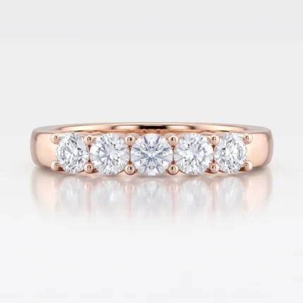 Rose gold band with five equally sized round diamonds set in bead-prong settings, side view showing shine and reflections