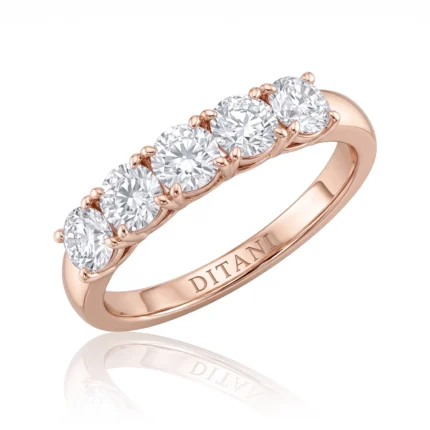 Rose gold ring with five surrounding diamonds set in prong settings, brand name engraved on the band (DITANI).