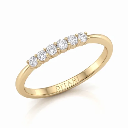 Gold ring with seven round diamonds in prong settings along the top; inner band engraved DITANI.