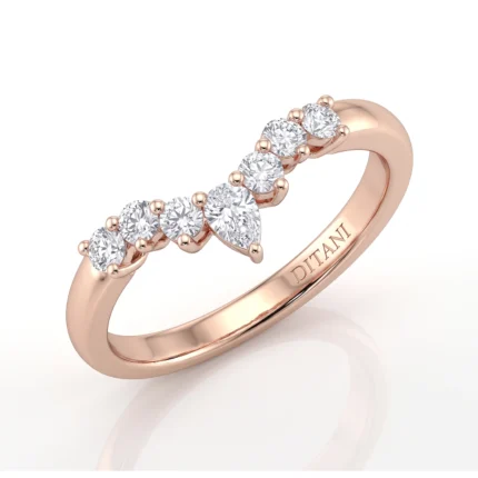 Rose gold ring featuring a curved row of round diamonds set in prong settings along the band’s top edge, form a leaflike arc.