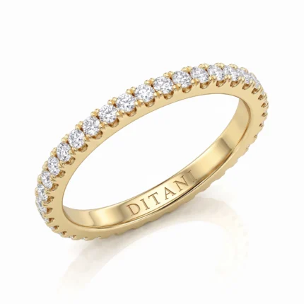 Gold eternity ring in yellow gold with a full circle of round diamonds; inner engraving reads DITANI.