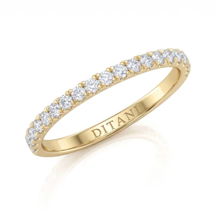 Gold ring with a row of diamonds set in prong settings along the top of a slender band, inner engraving visible as 'DITANI'.