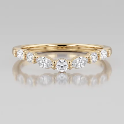 Gold ring with a row of round diamonds along the top half, centered by a larger central diamond with gold bead accents on the band.