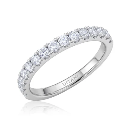 Silver ring with a row of round-cut diamonds in prong settings along the top half of the band; inner side engraved with 'DITANI'