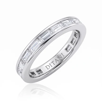 Silver ring featuring a row of baguette-cut diamonds set around the band; elegant jewelry design.
