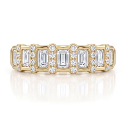 Gold ring featuring alternating emerald-cut and round diamonds on a polished band.