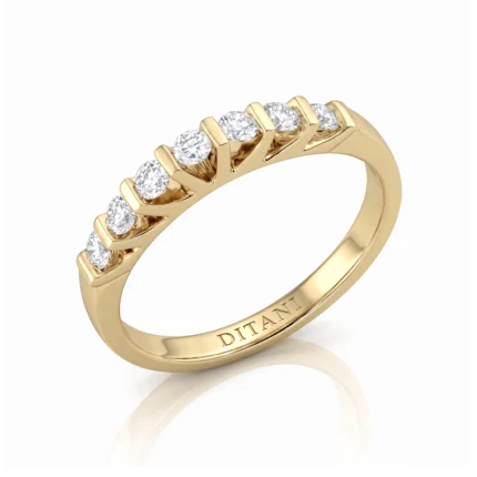 Gold ring with a row of round diamonds set along the top, band engraved 'DITANI' on the inside edge.