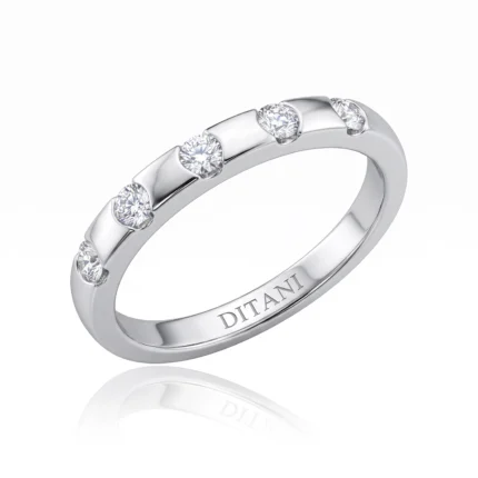 Polished silver-toned ring with five bezel-set round diamonds along the band; inner engraving reads DITANI outside view shown.