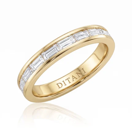 Gold band ring with a row of rectangular baguette diamonds set along the top edge, interior engraved with DITANI