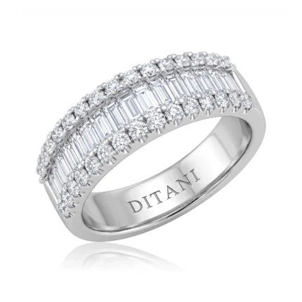 Three-row diamond eternity ring in white metal, with round-cut diamonds along the outer edges and a central row of baguette-cut stones.