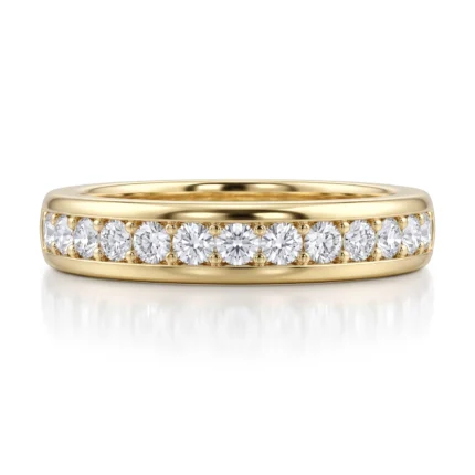 Yellow gold band with a row of round diamonds along the top half of the ring surface.
