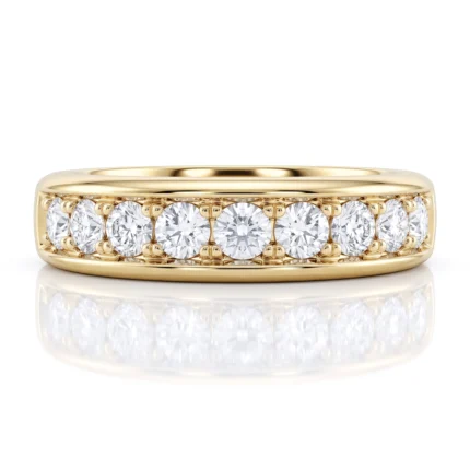 Gold ring with seven round diamonds set along the top half of the band.