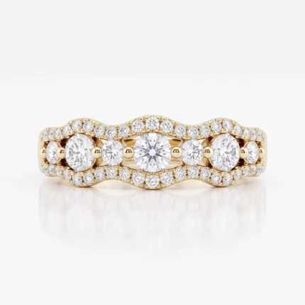 Yellow gold diamond ring with a central row of large stones flanked by smaller diamonds along a wavy band, full of sparkle.
