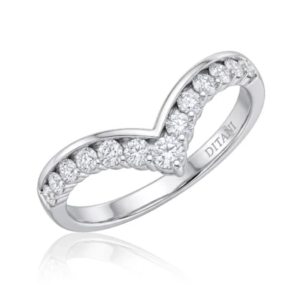 Silver ring with a curved band forming a heart-shaped negative space and pavé diamonds along the band.