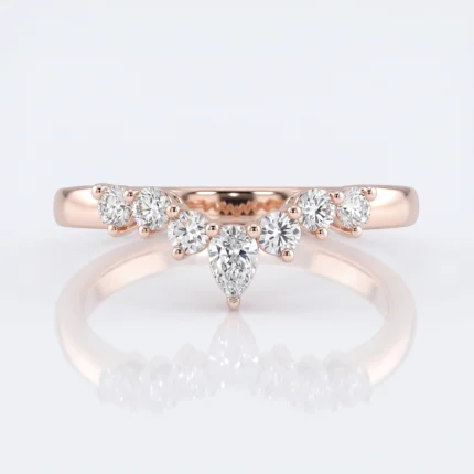 Rose gold engagement ring with a central pear-shaped diamond surrounded by a row of round diamonds along a curved band, on a light background.