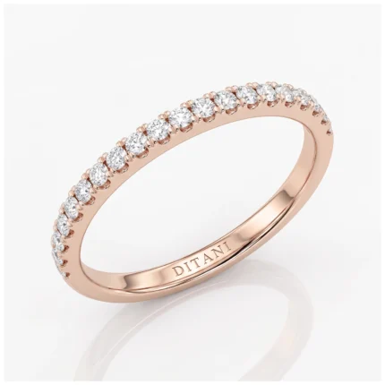 Rose gold diamond band ring with small round stones set along the top half and 'DITANI' engraved inside the band.