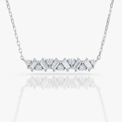 Silver necklace with a row of alternating round and baguette-cut diamonds on a chain, set in a curved design with a white background and soft reflection.