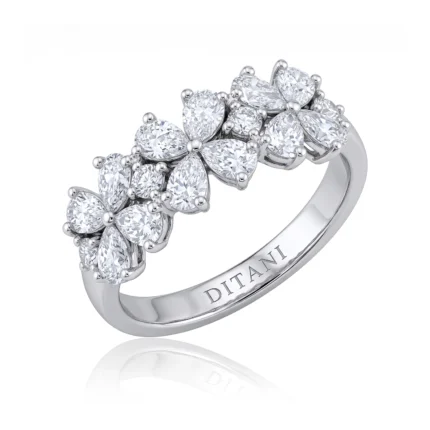 White metal ring featuring a row of six flower-shaped diamond clusters, each cluster with multiple prong-set stones and a polished band engraved with 'DITANI'