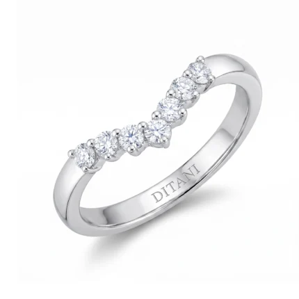Silver ring with six round-cut diamonds set along the top in prong settings, inner band engraved with DITANI.