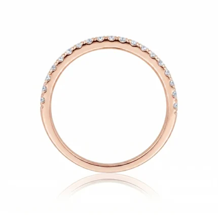 Rose gold ring with a row of small diamonds along the upper half of the band most of the way around the top edge of the ring