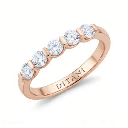 Rose-gold ring with five round diamonds set along the top and the brand name DITANI engraved on the inner band