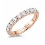 Rose gold ring with a row of round diamonds along the top half and 'DITANI' engraved inside the band.