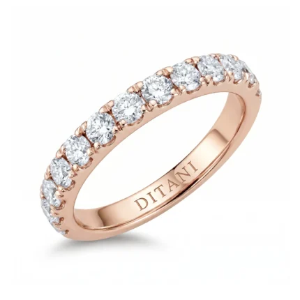 Rose gold ring with a row of round diamonds along the top half and 'DITANI' engraved inside the band.