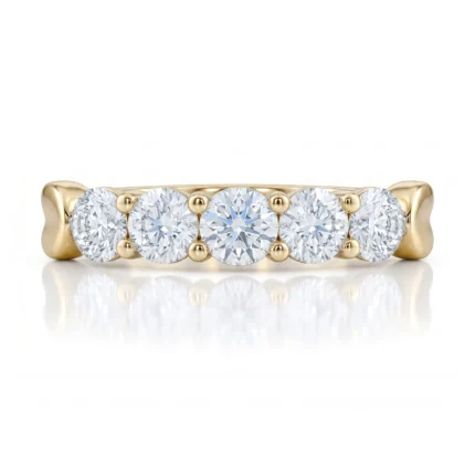 Gold ring with five round diamonds set in a row, separated by small gold beads.
