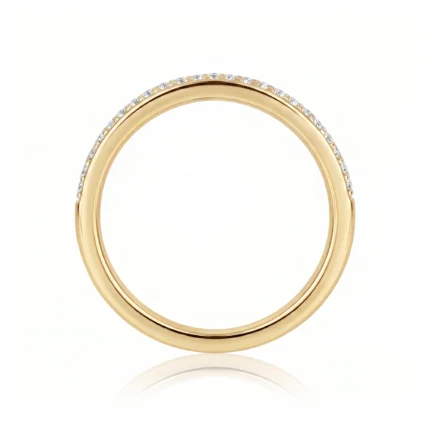 Gold ring with a row of small diamonds along the top edge, photographed on a white background