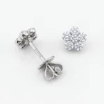 Diamond flower-shaped stud earring set in metal, five round stones forming petals with a central stone, displayed with a butterfly clutch back