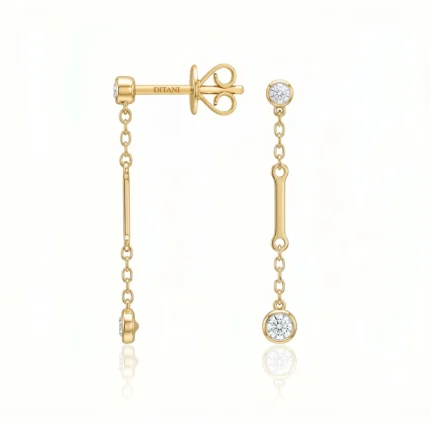 Gold drop earrings with chain links and round diamond accents on a pale background.