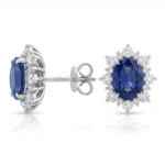 Silver stud earring with an oval deep-blue sapphire center surrounded by a halo of diamonds. The post shows the brand name 'DITANI'.