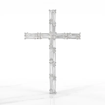 Diamond-encrusted cross pendant with vertical and horizontal baguette-cut diamonds arranged in a cruciform design, displayed against a white background.
