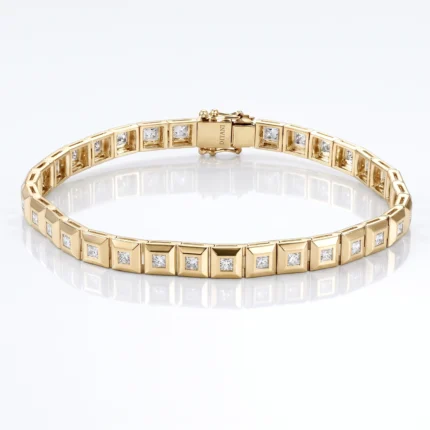 Gold bracelet with square-link sections set with small diamonds, on a white reflective surface.