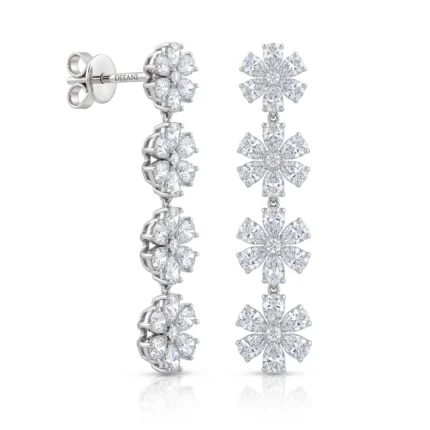 Bracelet on the left with linked diamond flower motifs and matching diamond flower drop earrings on the right in white gold or platinum setting.